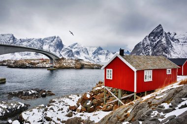 Beautiful winter landscape with traditional Norwegian fishing huts in the Lofoten islands, Norway clipart