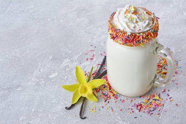 Deli vanilyalı milkshake ile çırpılmış krem ve renkli cam