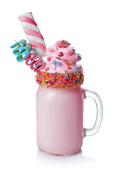 Crazy milk shake with pink whipped cream, marshmallow and colored candy in glass jar — Stock Photo, Image