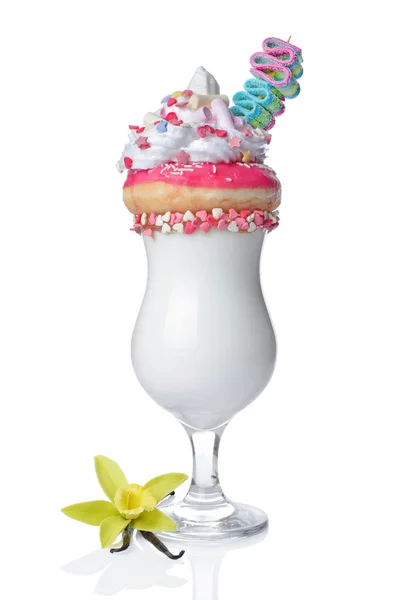 Crazy vanilla milk shake with pink donut, whipped cream, sprinkles, marshmallows and colored candy in glass — Stock Photo, Image