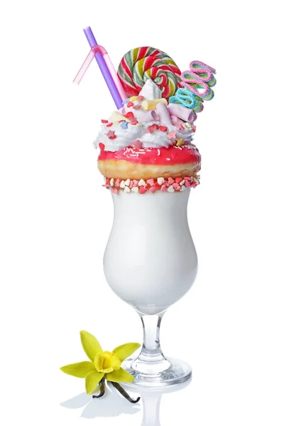 Crazy vanilla milk shake with pink donut, whipped cream, marshmallows, colored candy and lollipop in glass — Stock Photo, Image