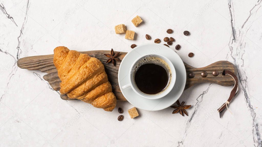 Appetizing crispy croissant and coffee for tasty breakfast