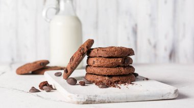 Chocolate chip cookies with bottle of mink for tasty break