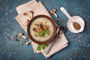 Bowl of vegetarian cream soup with forest mushrooms and spices