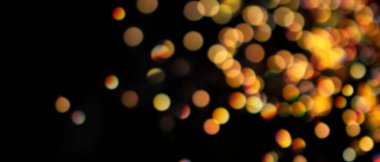 Siyah arkaplan üzerinde bokeh etkisi olan odaksız altın parıltı ve ışık pankartı
