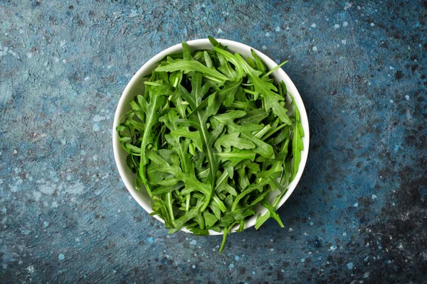 Vista Superior Ensalada Rúcula Vegetariana Sobre Fondo Hormigón Azul —  Fotos de Stock