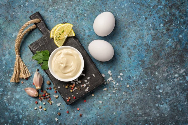 自制蛋黄酱配料的顶部视图 如鸡蛋 柠檬和蓝色混凝土背景上的香料 — 图库照片