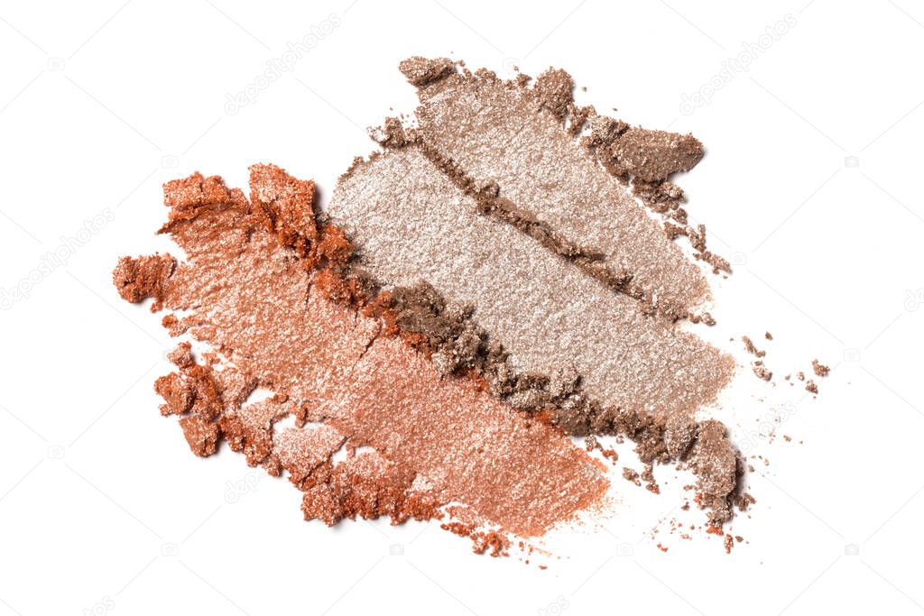Flat lay of brush stroke. Broken shiny color eyeshadow as sample of cosmetic beauty product isolated on white background