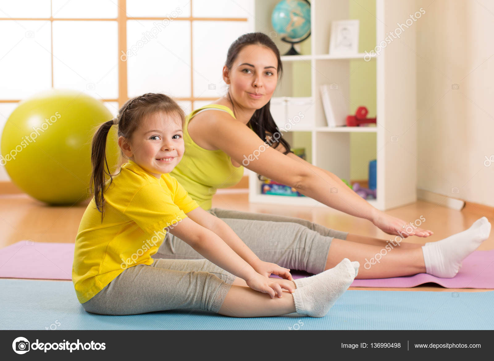 Child girl and her mother doing gym exercise at home — Stock Photo