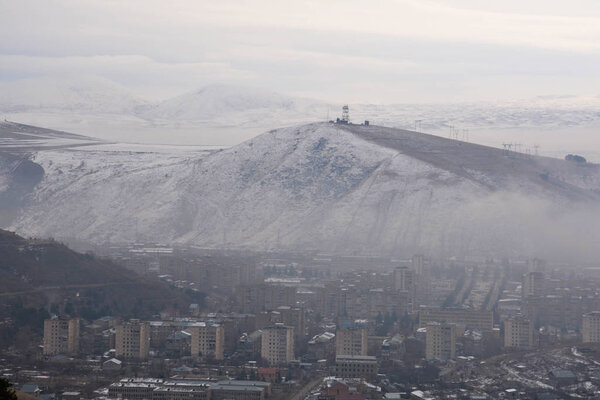 Hrazdan city in Armenia and snow mountains