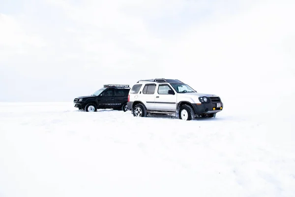 Two off-road vehicles high in the mountains