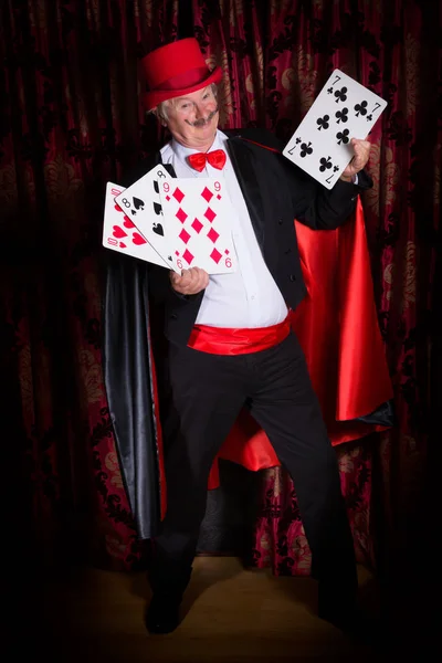 Happy magician with cards — Stock Photo, Image