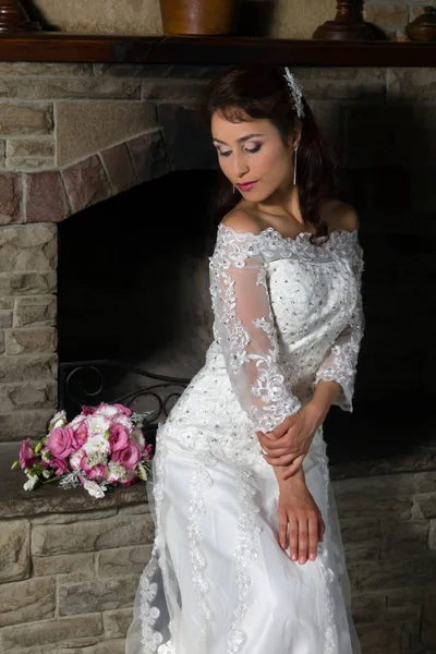 Bride in front of fireplace — Stock Photo, Image