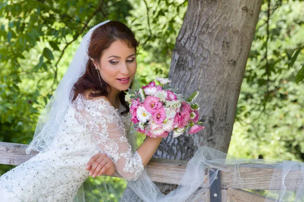 Dreamy bride in garden — Stock Photo, Image