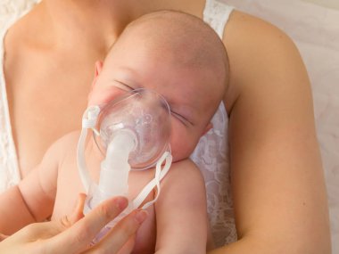 Baby with nebuliser clipart
