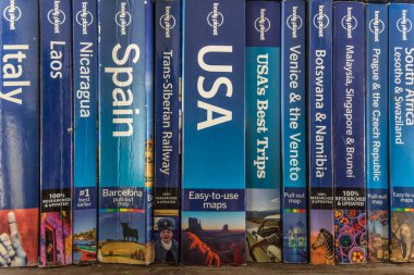 Antwerp, Belgium, September 2019, Illustrative Editorial: bunch of used Lonely Planet travel guide books in a row clipart