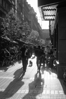 Bilbao, İspanya, Mayıs 2012: Şehir merkezindeki işlek sokak sahnesi, siyah beyaz insanların sokakta yürüdüğü ve barın teraslarında oturduğu