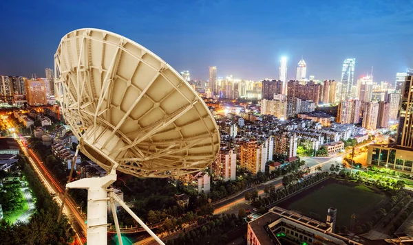 Satellite antenna and urban landscape — Stock Photo, Image