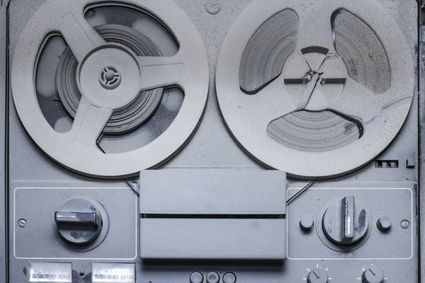 an old reel-to-reel tape recorder and gramophone in a thick laye