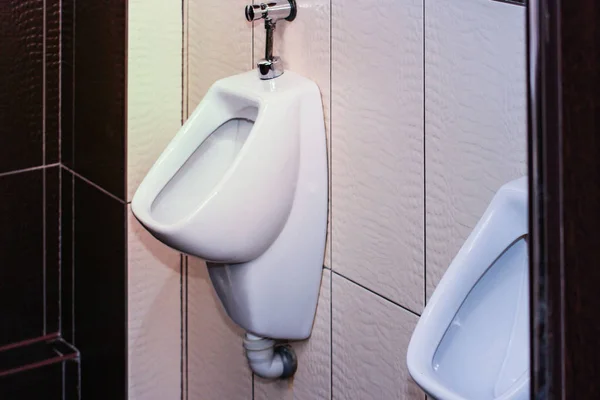 Erkekler tuvaletinde sırada beyaz pisuar var. Rahat erkek tuvaleti. — Stok fotoğraf