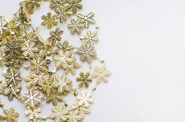 Beyaz zemin üzerine altın Noel kar taneleri