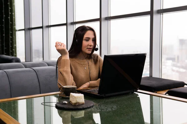 Chica lleva un poco de emisión en línea desde la cafetería —  Fotos de Stock