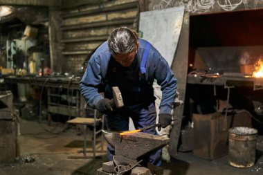 male traditional blacksmith at work
