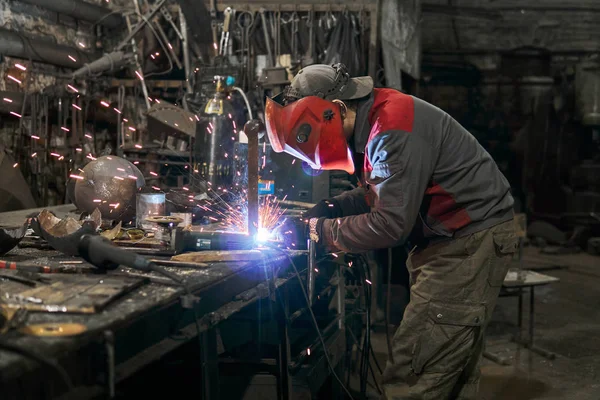 welder works in a small workshop