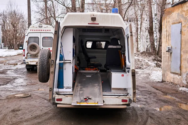 俄罗斯珀姆 2020年3月25日 两辆救护车在一个肮脏的春天城市的景观中 其中一辆敞开着大门 准备接待一位病人 — 图库照片