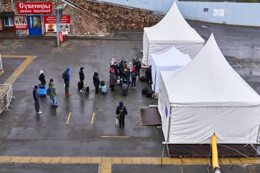 Perm, Rusya - 25 Nisan 2020: Yolcular Coronavirus COVID-19 salgını sırasında bir tren istasyonuna yerleştirilen sıcaklık ölçüm noktalarından geçtiler