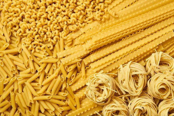 Golden Background Scattered Dry Pasta Various Varieties — Stock Photo, Image