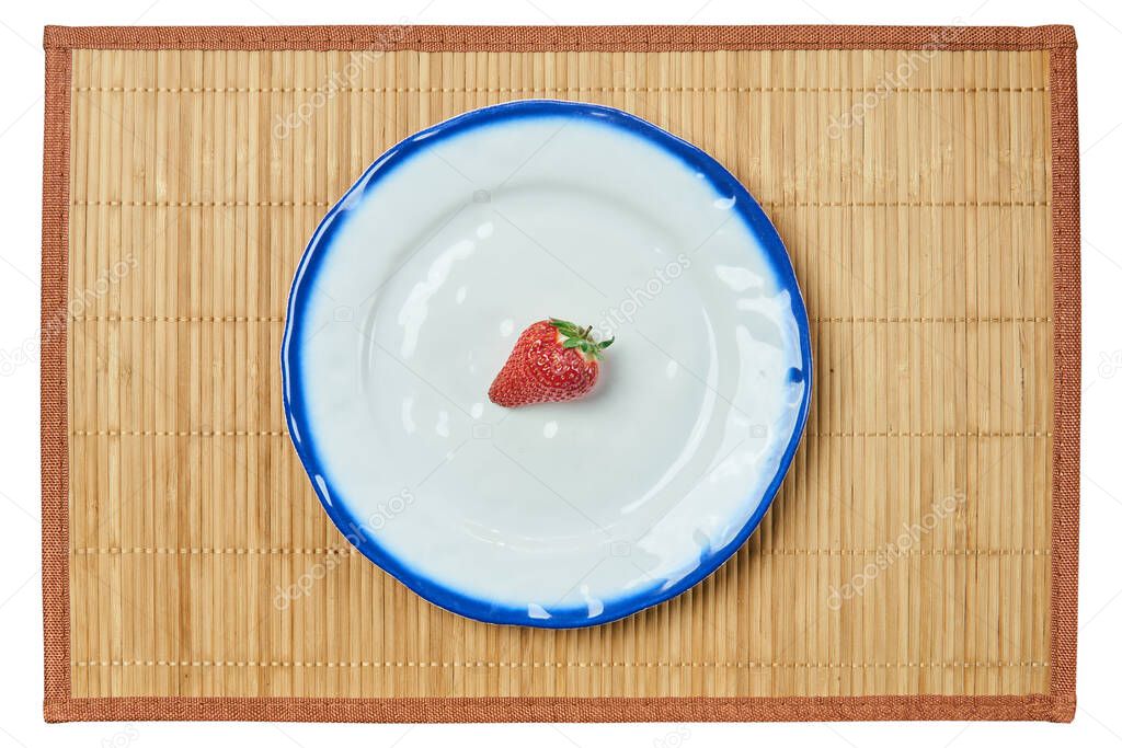 lonely berry of a strawberry on a white plate with a blue ri