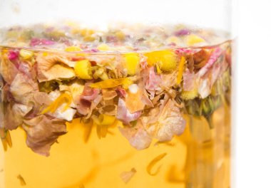 close up Hot medicine herbal chamomile flowers yellow tea in french press tea pot