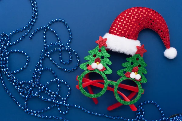 Christmas Headband, Funny Glasses With Green Trees and Beads on Blue Background.