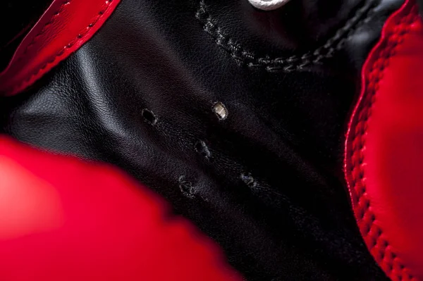 Close-up elements of red boxing leather gloves