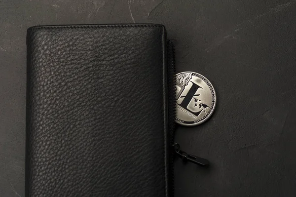 Close-up of a bitcoin coin lies on a black wallet — Stock Photo, Image