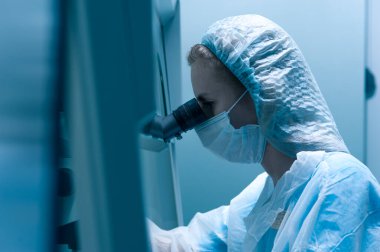 Female lab technician in a protective mask