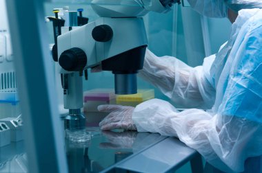 Female lab technician in a protective mask