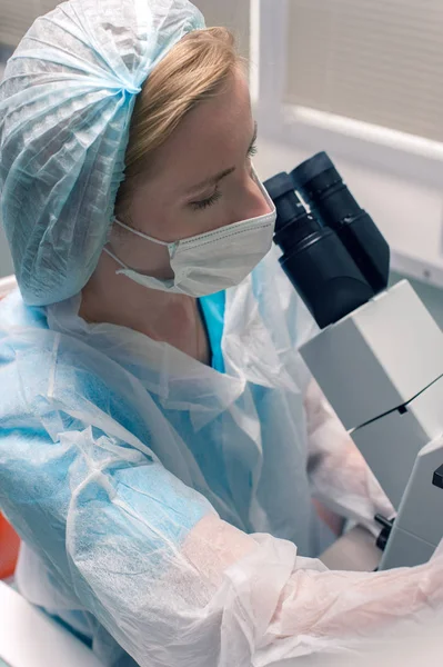 Female lab technician in a protective mask