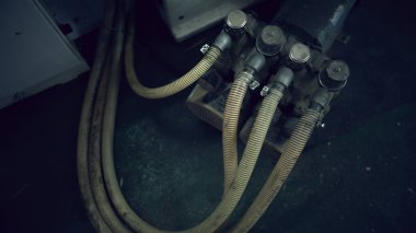 Four old dusty plastic corrugated pipe joined in machine