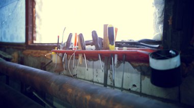 Screwdrivers on a red stand rack in workshop