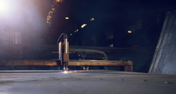 Close-up Of A Laser Cutters Head Cutting A Sheet Of Iron