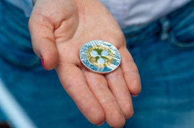 Young unidentified woman holding a etherium coin