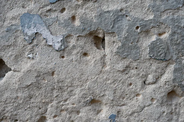 Primo piano - muro di pietra grigio-marrone nella vecchia facciata della casa — Foto Stock