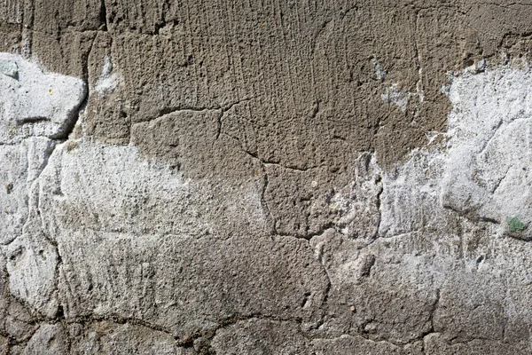 Primo piano - muro di pietra grigio-marrone nella vecchia facciata della casa — Foto Stock