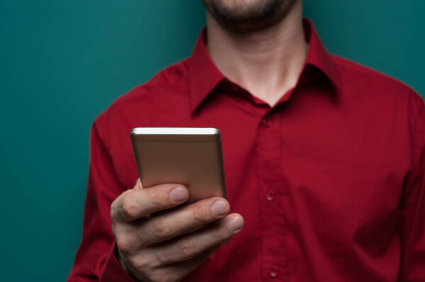 Portrait of a positive young man in glasses with phone