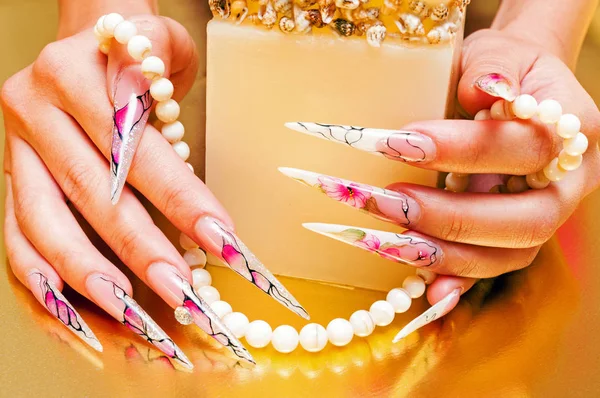 Artificial nails and pearls Stock Image