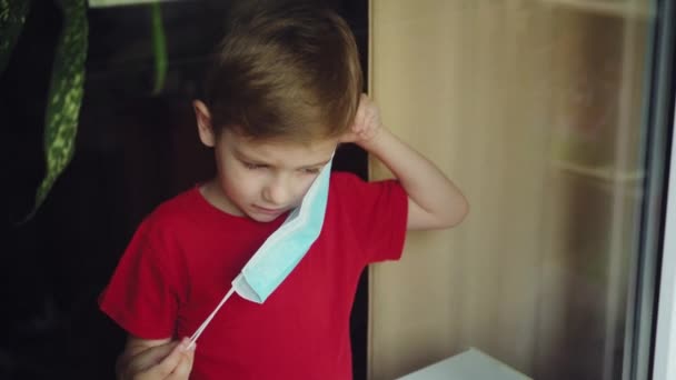 Child Wears Mask Window — Stock Video