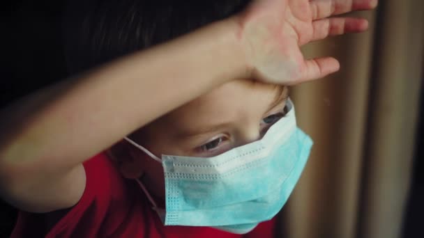 Young Boy Medical Mask Looks Out Window Isolation Quarantine Coronavirus — Stock Video