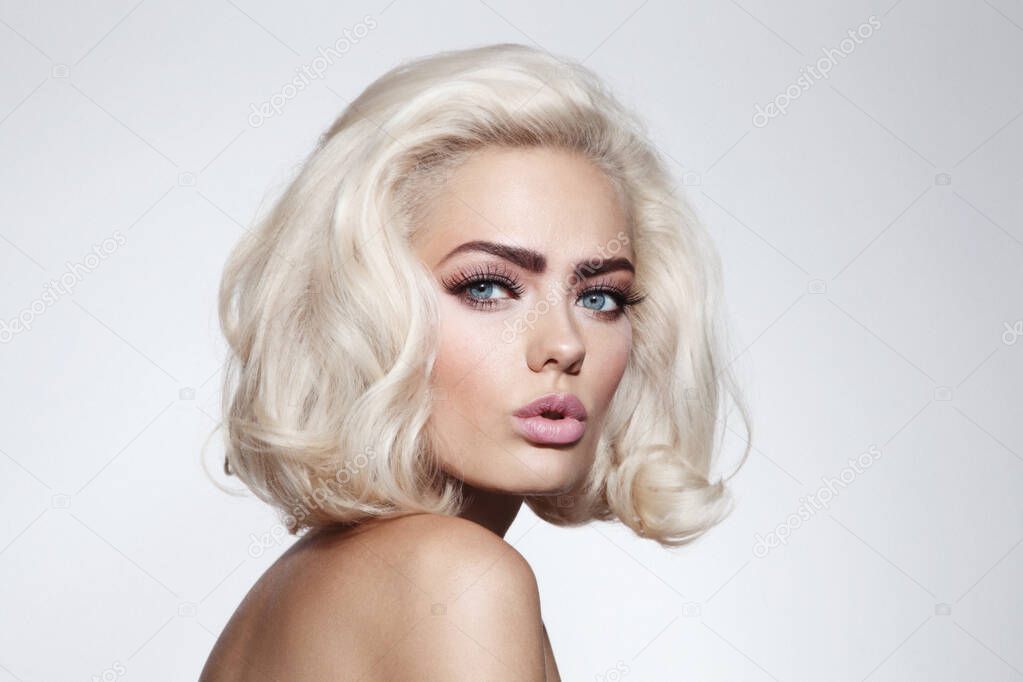 Vintage style portrait of young beautiful blonde girl with fancy makeup